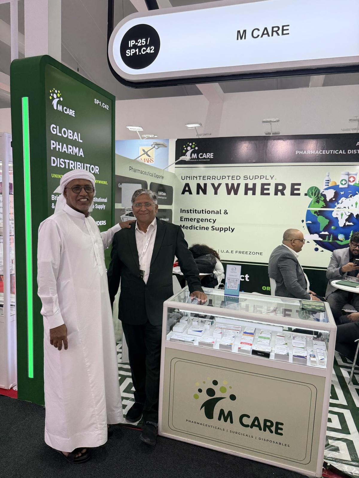 M Care booth IP25 at WHX Dubai 2026 — "Uninterrupted Supply Anywhere" wall graphic visible.